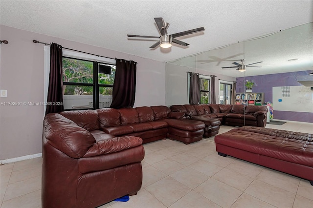 11733 NW 11th St, Pembroke Pines, FL 33026 - living room featuring a ceiling fan, a textured ceiling, light tile patterned floors, healthy amount of natural light, and baseboards