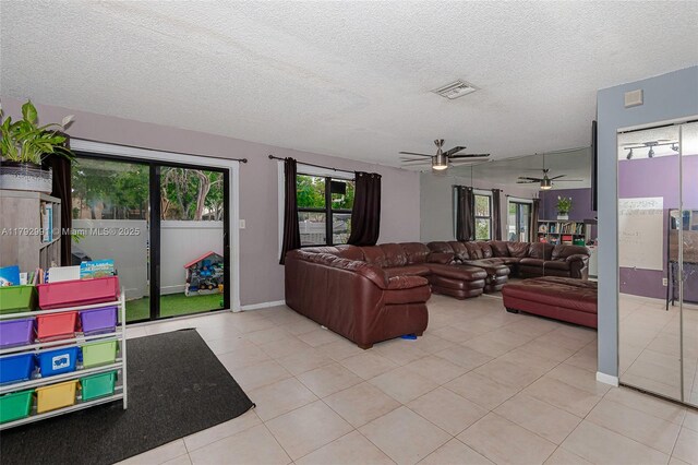11733 NW 11th St, Pembroke Pines, FL 33026 - tiled living area with a ceiling fan, a textured ceiling, and baseboards