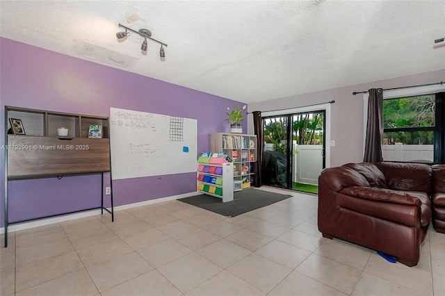 11733 NW 11th St, Pembroke Pines, FL 33026 - living area with a textured ceiling, tile patterned flooring, and baseboards