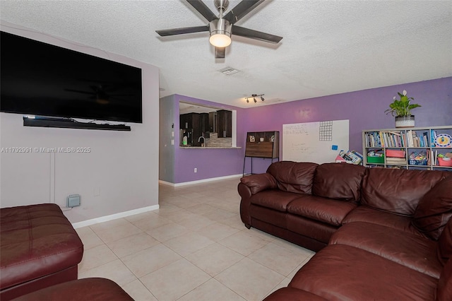 11733 NW 11th St, Pembroke Pines, FL 33026 - living area with a ceiling fan, a textured ceiling, light tile patterned floors, and baseboards