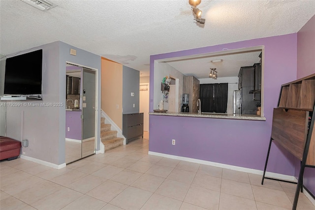 11733 NW 11th St, Pembroke Pines, FL 33026 - unfurnished living room featuring light tile patterned floors, track lighting, stairway, a textured ceiling, and baseboards
