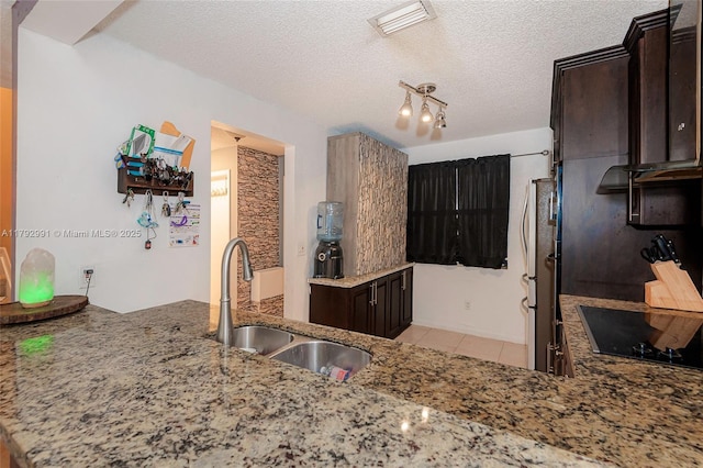 11733 NW 11th St, Pembroke Pines, FL 33026 - kitchen featuring a sink, black electric stovetop, light stone countertops, dark brown cabinetry, and light tile patterned floors