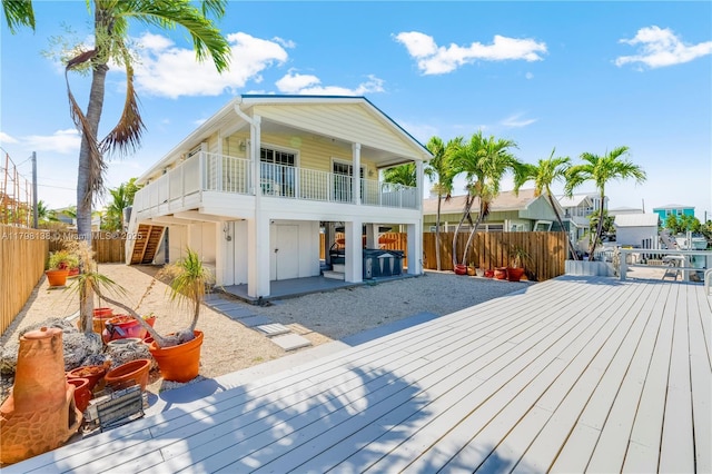 rear view of house featuring a fenced backyard, a patio, and a deck