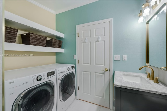 washroom with washing machine and clothes dryer and ornamental molding