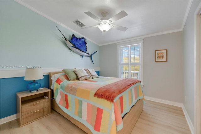 bedroom with baseboards, wood finished floors, crown molding, and a ceiling fan