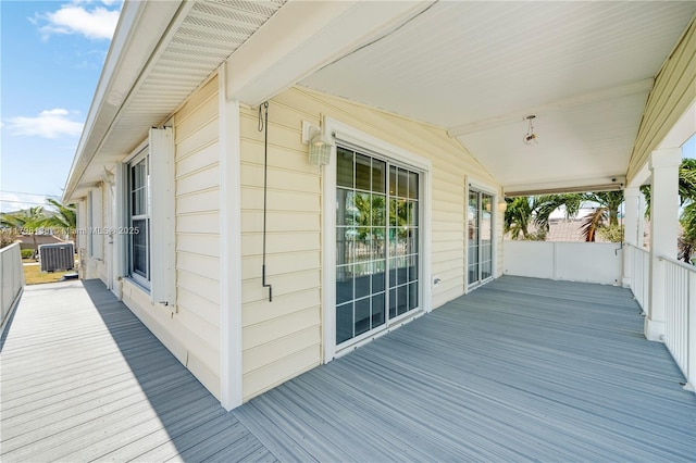 deck with a porch and cooling unit