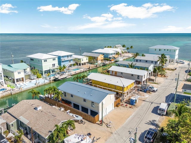 aerial view of residential area featuring a nearby body of water