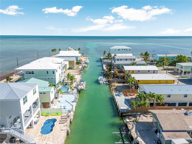 aerial perspective of suburban area with a nearby body of water and a pool