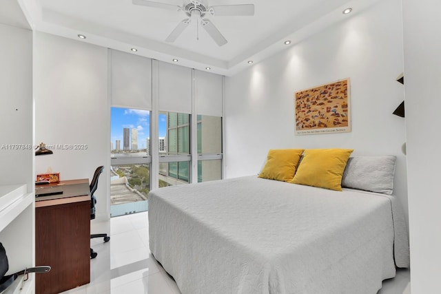 bedroom with recessed lighting, a desk, a skyline view, and light tile patterned floors