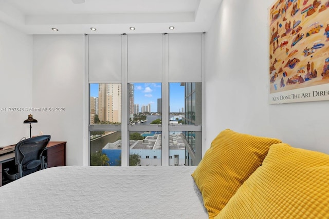 bedroom with recessed lighting, a view of skyline, and a desk