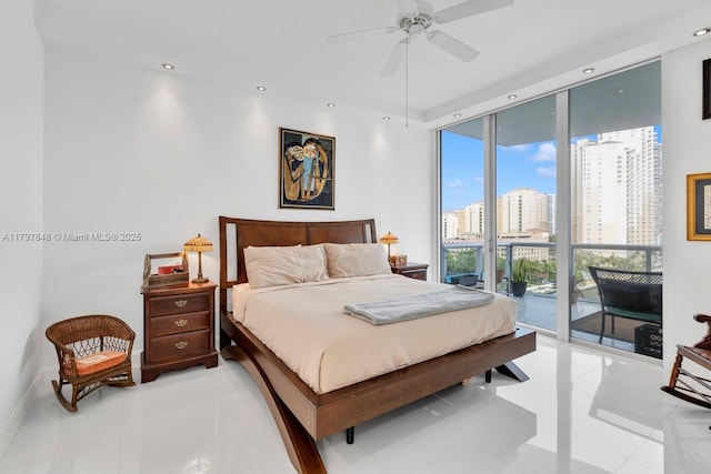 bedroom featuring expansive windows, access to exterior, light tile patterned floors, a city view, and recessed lighting