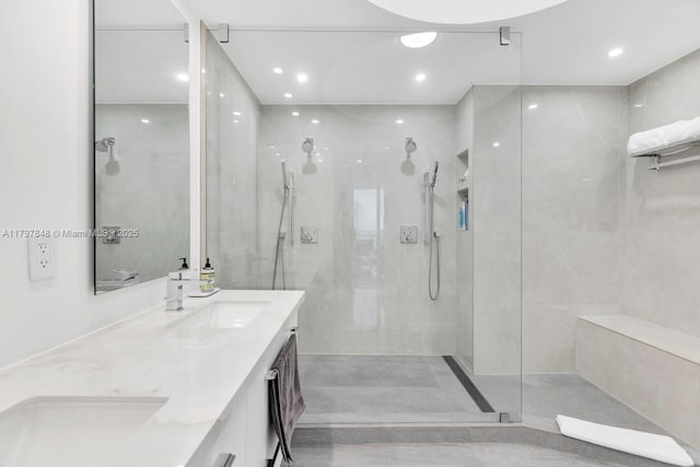 full bath with a walk in shower, recessed lighting, and double vanity