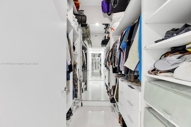 walk in closet featuring light tile patterned flooring