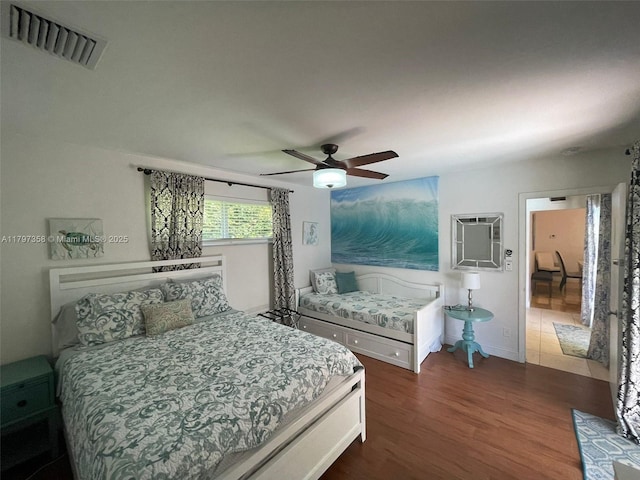 4410 N Buchanan St, Hollywood, FL 33021 - bedroom with dark wood finished floors, an AC wall unit, a ceiling fan, and baseboards