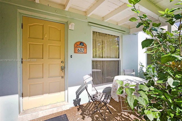 doorway to property with stucco siding