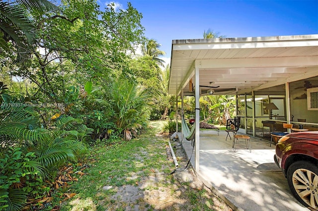 view of yard with a patio and ceiling fan