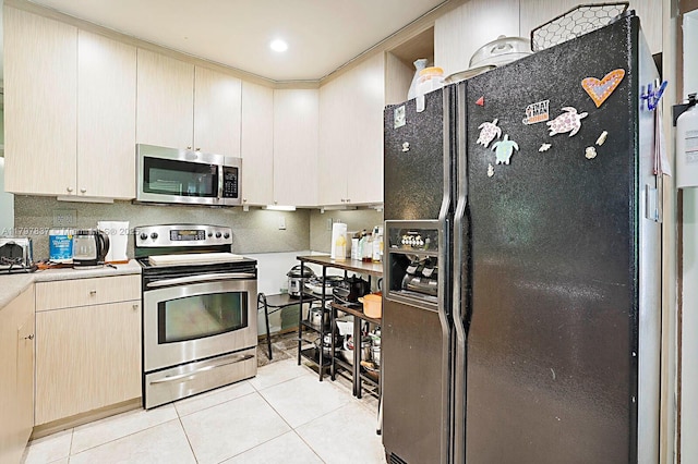 602 S Caloosahatchee Ave, Jupiter, FL 33458 - kitchen featuring appliances with stainless steel finishes, light tile patterned flooring, light countertops, and backsplash