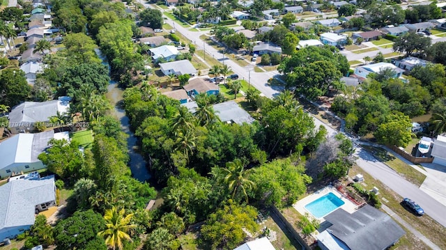 view of property location with nearby suburban area and a pool area