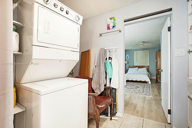 602 S Caloosahatchee Ave, Jupiter, FL 33458 - laundry area featuring stacked washer and clothes dryer, ceiling fan, and light tile patterned floors
