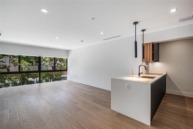 204 Sunrise Dr Unit 204D, Key Biscayne, FL 33149 - kitchen featuring a sink, wood finished floors, light countertops, hanging light fixtures, and recessed lighting