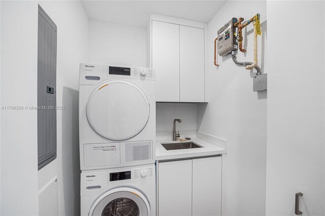 204 Sunrise Dr Unit 204D, Key Biscayne, FL 33149 - laundry area with stacked washer / drying machine, bar with sink, and cabinet space