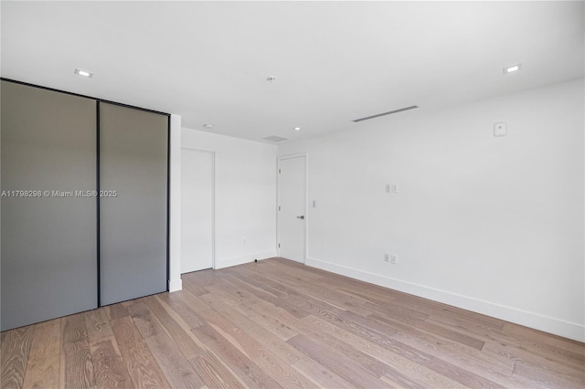 204 Sunrise Dr Unit 204D, Key Biscayne, FL 33149 - unfurnished bedroom with light wood finished floors, baseboards, and a closet