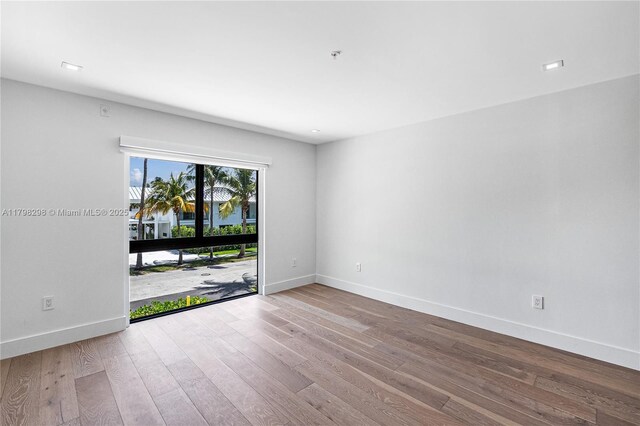 204 Sunrise Dr Unit 204D, Key Biscayne, FL 33149 - unfurnished room with baseboards, wood finished floors, and fire sprinkler in ceiling