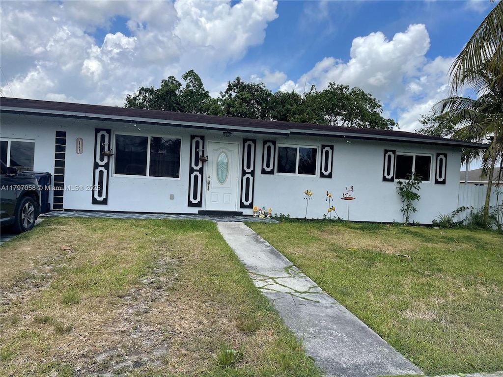 19201 SW 318th Ter, Homestead, FL 33030 - ranch-style house featuring stucco siding and a front lawn