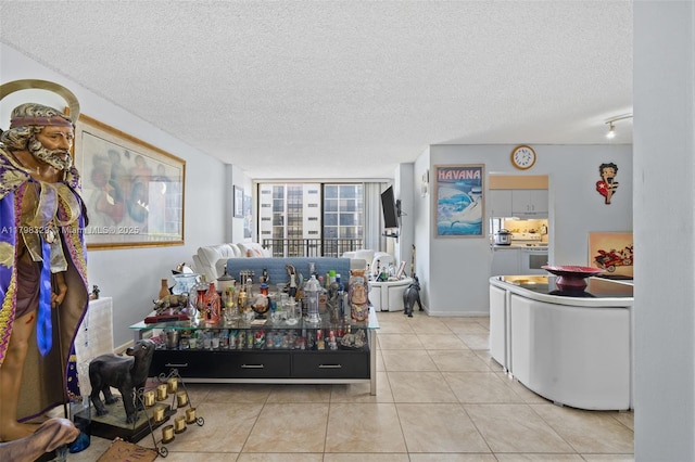 17021 N Bay Rd Unit 727, Sunny Isles Beach, FL 33160 - living room featuring a textured ceiling and light tile patterned floors