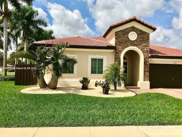 1010 NE 36th Ave, Homestead, FL 33033 - mediterranean / spanish-style house featuring a tiled roof, a garage, stucco siding, a front lawn, and driveway