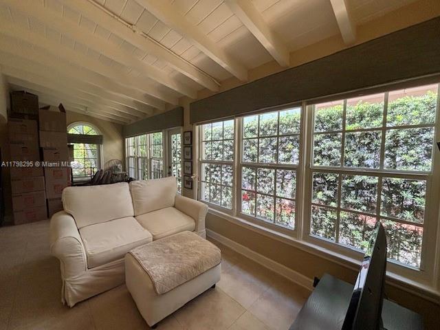 sunroom / solarium featuring tile patterned floors and baseboards