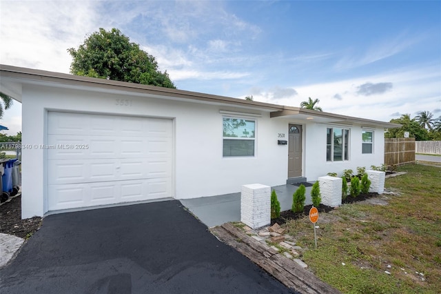 3531 NW 26th St, Lauderdale Lakes, FL 33311 - ranch-style house featuring fence, stucco siding, a garage, and driveway