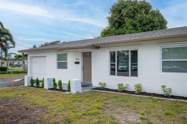 3531 NW 26th St, Lauderdale Lakes, FL 33311 - ranch-style home featuring stucco siding, roof with shingles, a garage, and a front lawn