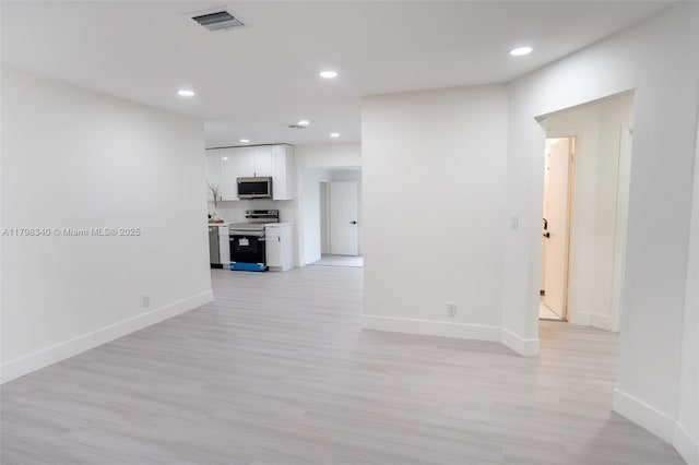 3531 NW 26th St, Lauderdale Lakes, FL 33311 - hallway with light wood finished floors, baseboards, and recessed lighting