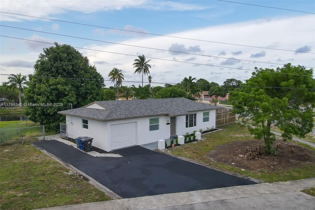 3531 NW 26th St, Lauderdale Lakes, FL 33311 - ranch-style house featuring stucco siding, fence, driveway, and a detached garage