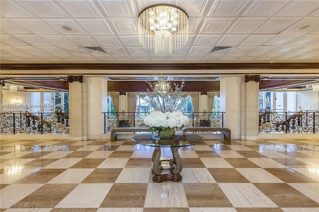 building lobby with ornamental molding and an ornate ceiling