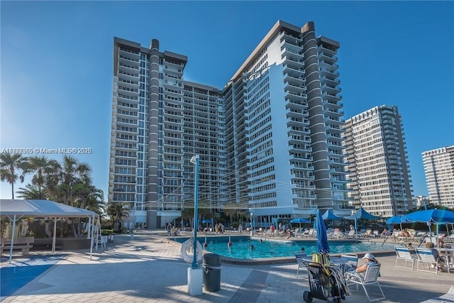 community pool featuring a gazebo and a patio area