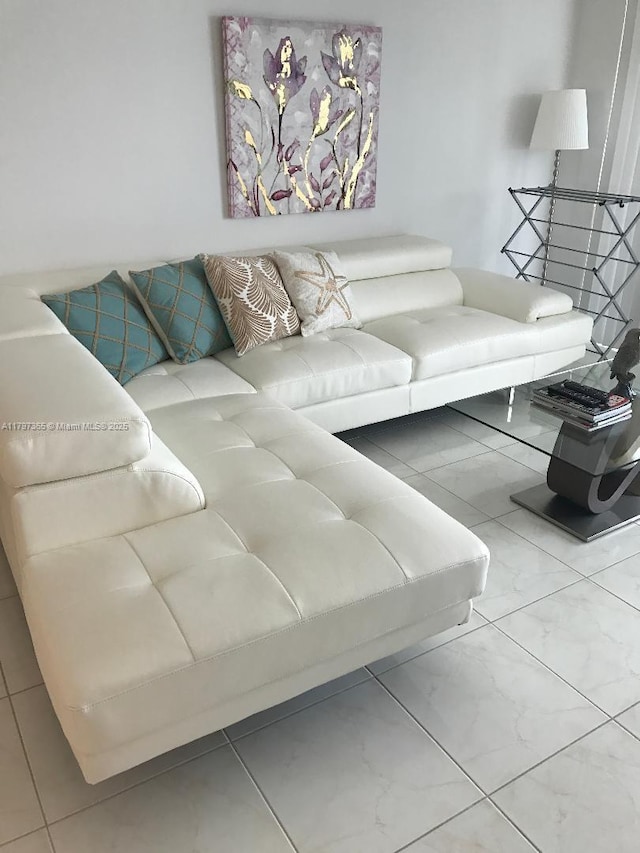 living area with marble look tile flooring