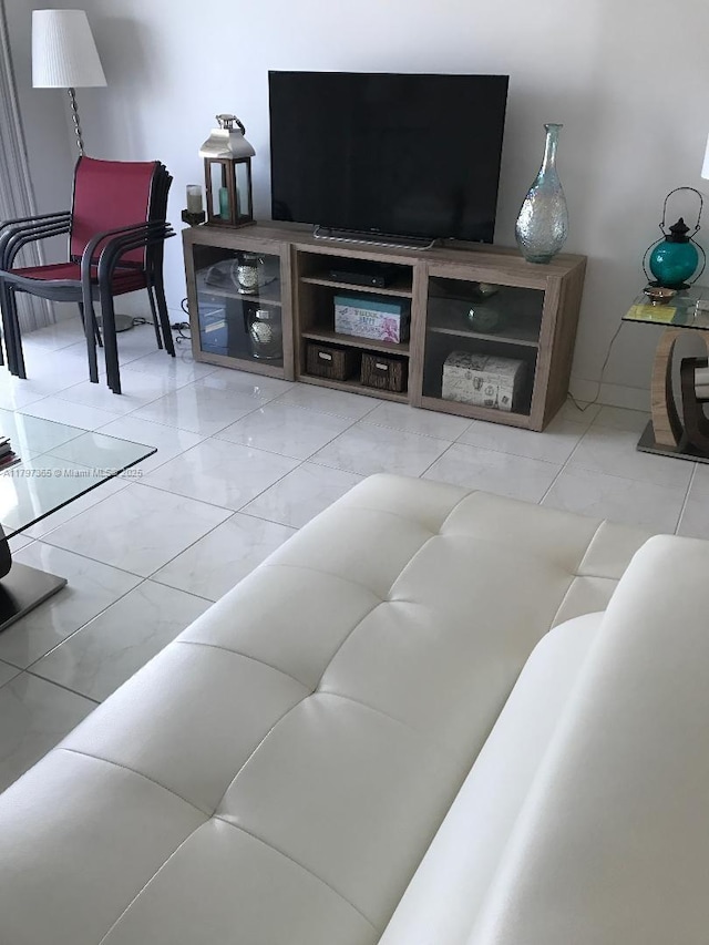 living area featuring marble look tile flooring