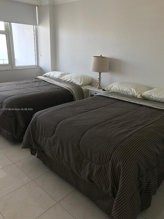 bedroom with light tile patterned floors