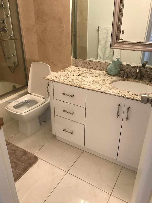 full bath featuring marble finish floors, toilet, combined bath / shower with glass door, and vanity