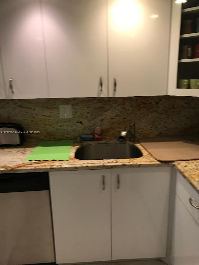 kitchen with stainless steel dishwasher and white cabinets