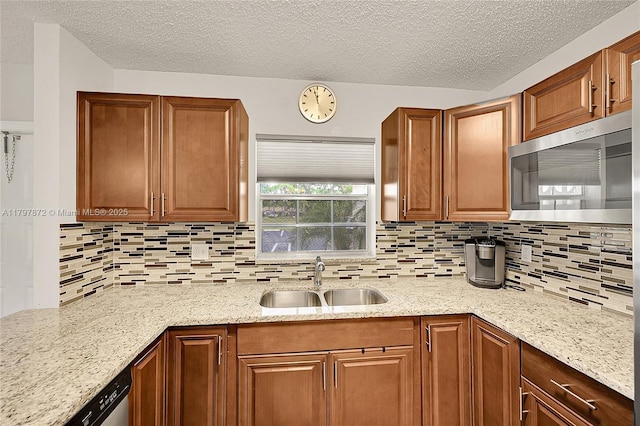 14030 Nesting Way Unit D, Delray Beach, FL 33484 - kitchen featuring stainless steel appliances, backsplash, a textured ceiling, and light stone counters