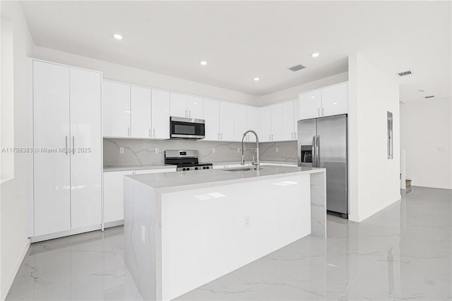 kitchen featuring appliances with stainless steel finishes, a sink, light marble finish flooring, decorative backsplash, and recessed lighting