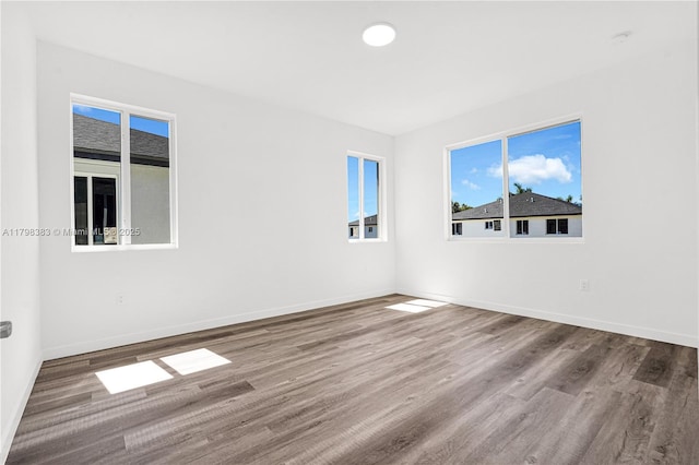 unfurnished room featuring wood finished floors and baseboards