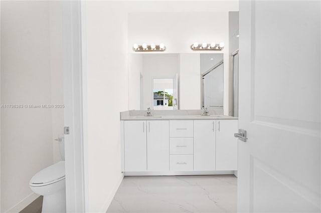 full bath with marble finish flooring, baseboards, double vanity, and toilet
