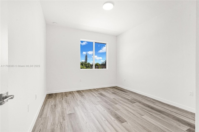 unfurnished room featuring light wood-type flooring and baseboards
