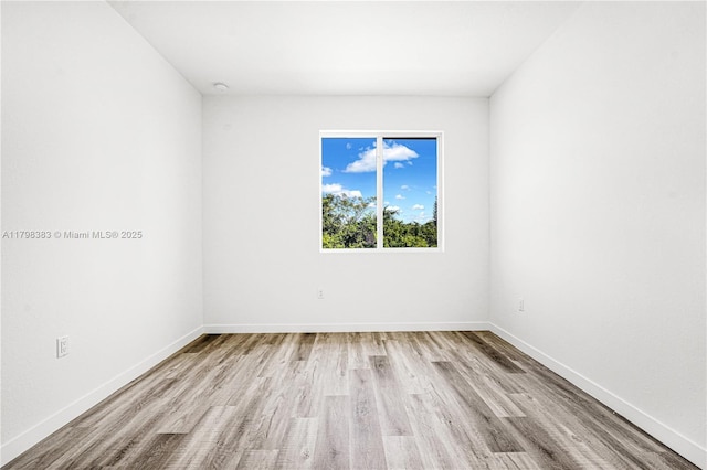unfurnished room with wood finished floors and baseboards