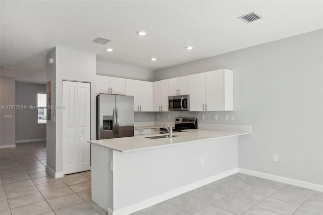 28625 SW 132nd Ct, Homestead, FL 33033 - kitchen featuring stainless steel appliances, light countertops, a peninsula, a sink, and light tile patterned floors