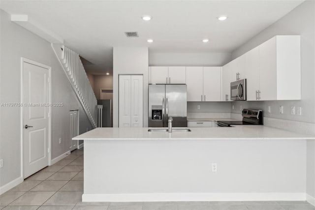 28625 SW 132nd Ct, Homestead, FL 33033 - kitchen featuring appliances with stainless steel finishes, a sink, light countertops, a peninsula, and recessed lighting